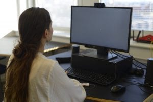 woman looking at a screen with eye tracking and gsr